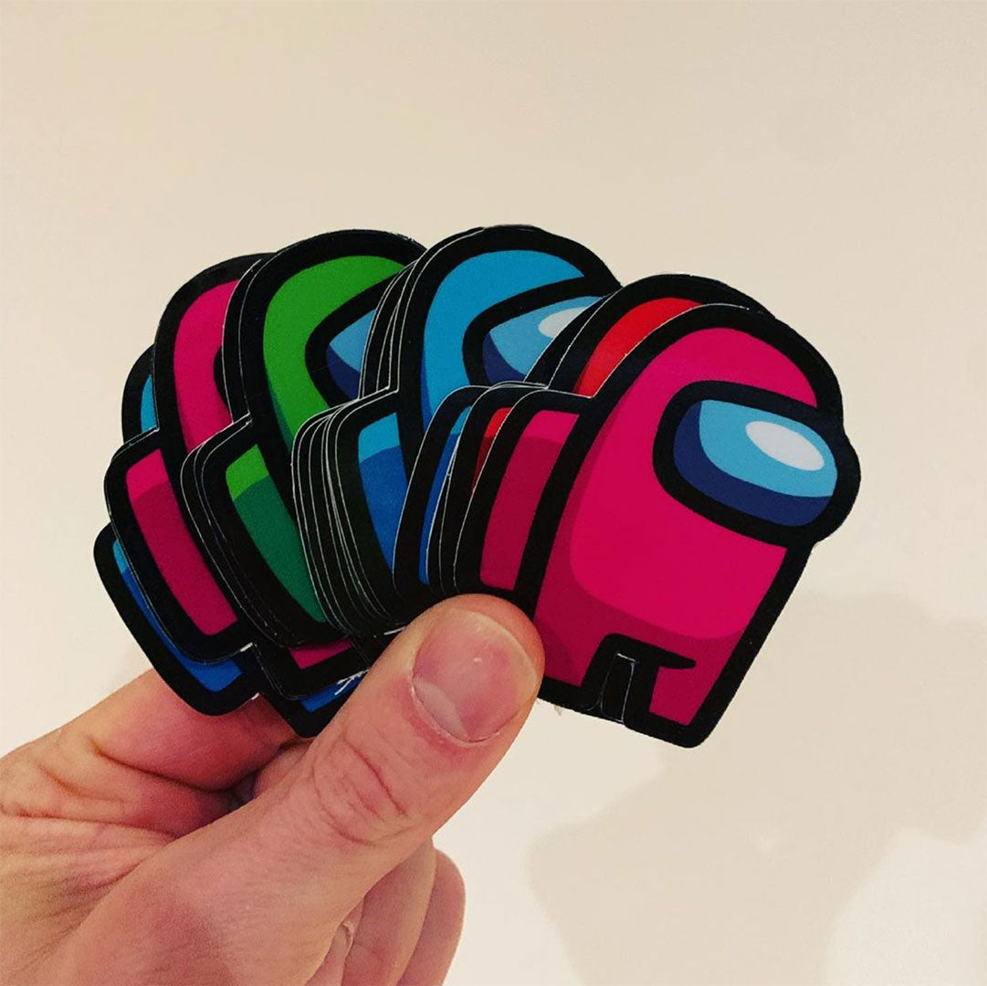 Hand holding custom die cut sticker with vibrant full-colour print